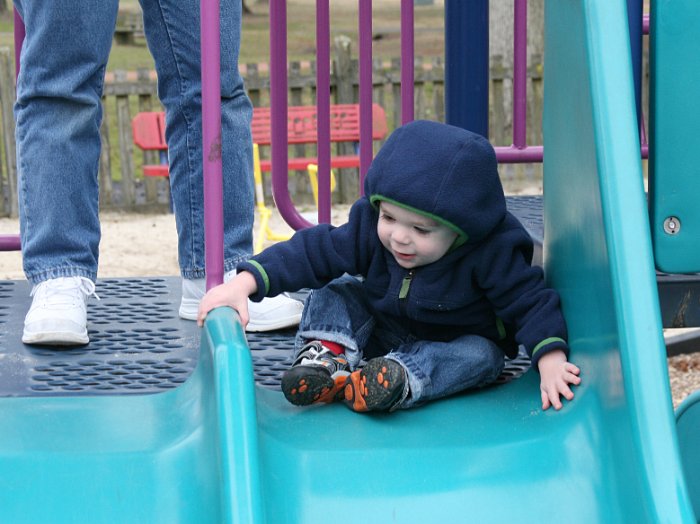 Pulling himself onto the slide